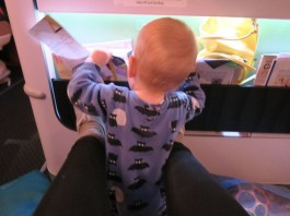 Flying alone with baby: 7 tips for success, baby exploring the plane