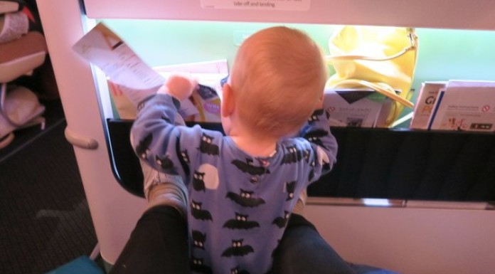 Flying alone with baby: 7 tips for success, baby exploring the plane