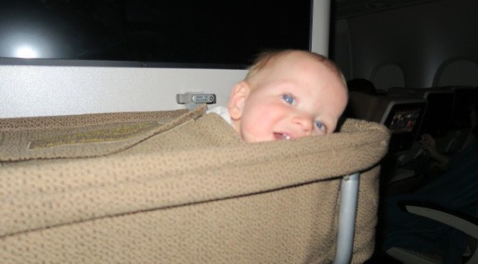 Flying with an infant: long haul, baby in bassinet on plane