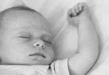 Sleeping baby with arm extended